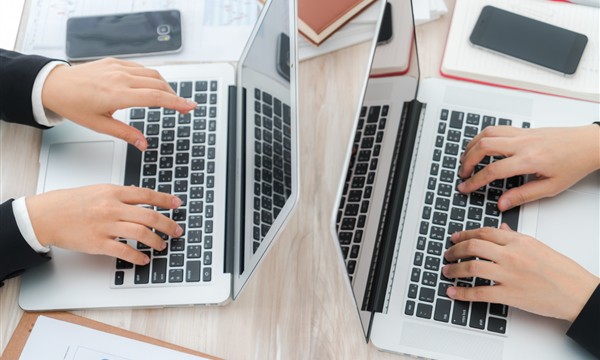 Two laptops compared by size keyboard and working format