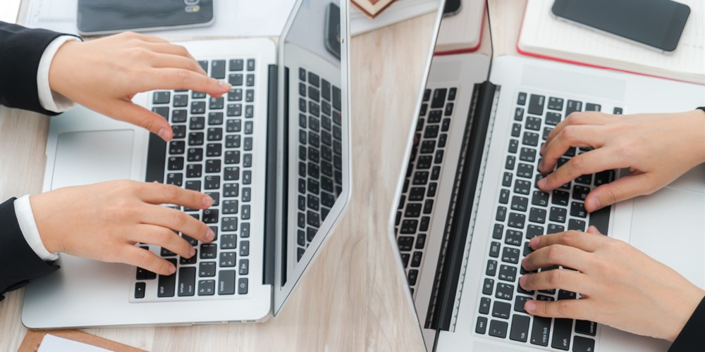 Two laptops compared by size keyboard and working format