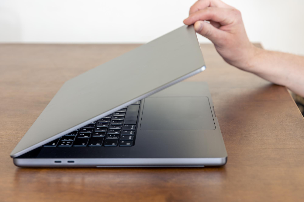 Laptop being opened for physical condition and refurbished warranty inspection