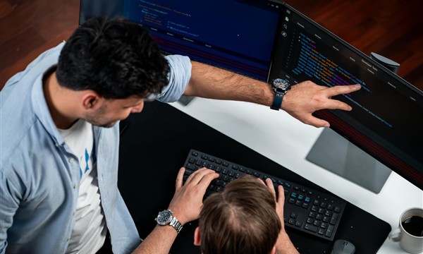 Developers inspecting website code during a technical SEO audit