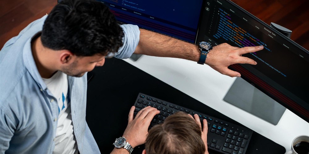 Developers inspecting website code during a technical SEO audit